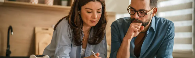 Couple reviewing household budget and potential HVAC rebates at home