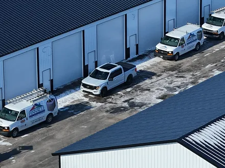 Aerial view of the Pinnacle Air Solutions service van fleet lined up at the loading docks
