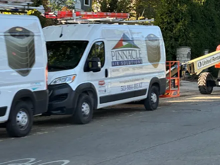 A Pinnacle Air Solutions service van parked on a tree-lined Cincinnati residential street