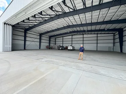 Interior of an open steel commercial building being fitted out