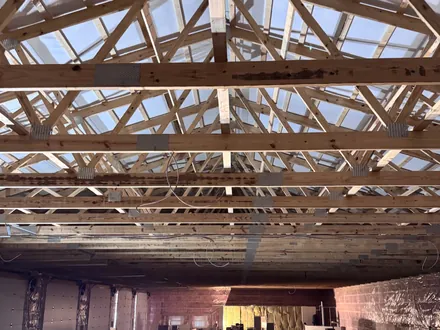 Roof trusses over the open interior of a building under construction