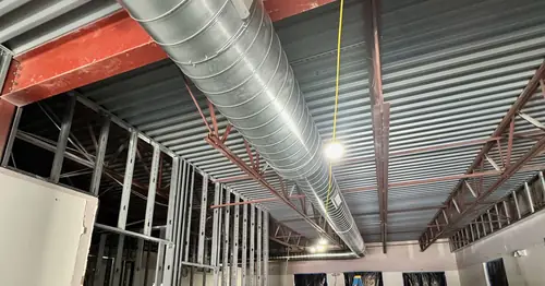 Spiral ductwork installed through a steel-framed commercial building