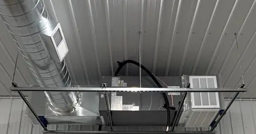 Ceiling-mounted ductwork and air handling equipment installed by Pinnacle Air Solutions