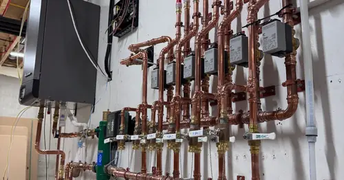 Hydronic manifold with copper piping installed by Pinnacle Air Solutions