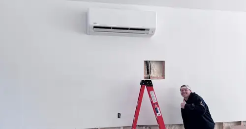 Pinnacle Air Solutions technician installing a wall-mounted mini-split indoor unit