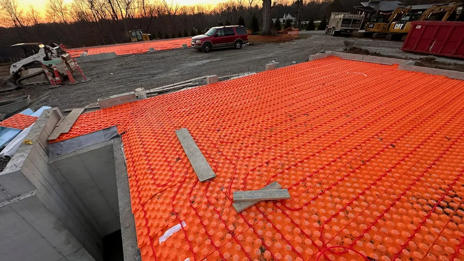 Radiant floor tubing installation photographed at golden hour
